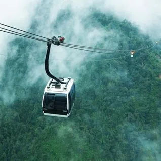 Tourist enjoying Gondola Ride in Gulmarg with snow-covered Himalayan peaks