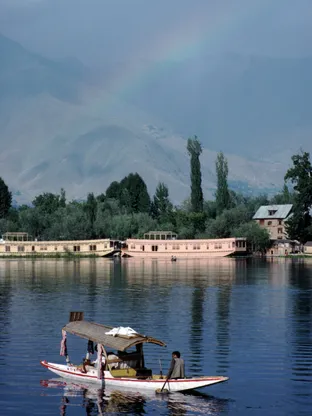 Shikara ride on Dal Lake in Srinagar with views of houseboats and Himalayas